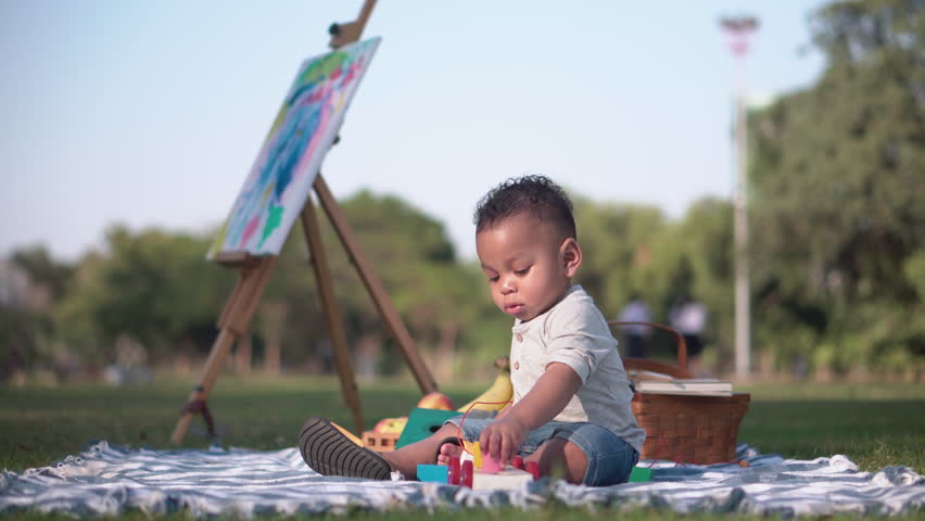 Child playing in the park, Cute little boy play toy at the garden, Child boy playing with little wooden toy cars outdoor | Shutterstock HD Video #1099290449
