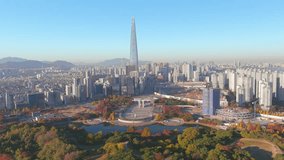 Seoul: Aerial view of capital city of South Korea, Olympic Park, skyline with modern high-rise buildings and Lotte World Tower in autumn, clear blue sky - landscape panorama of East Asia from above
