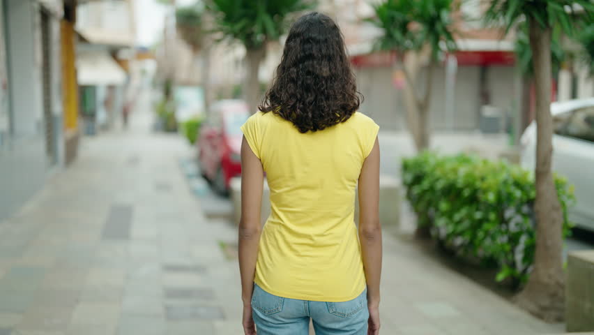 Young african american woman standing with arms crossed gesture at street