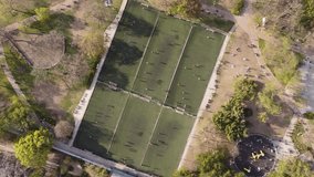 Timelapse of six small soccer football training fields. Aerial top-down orbiting directly above