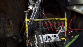 An African miner excavates rock operating an underground drill rig in a deep ore mine. - Powered by Shutterstock - Get 15% off with code: PIKWIZARD15