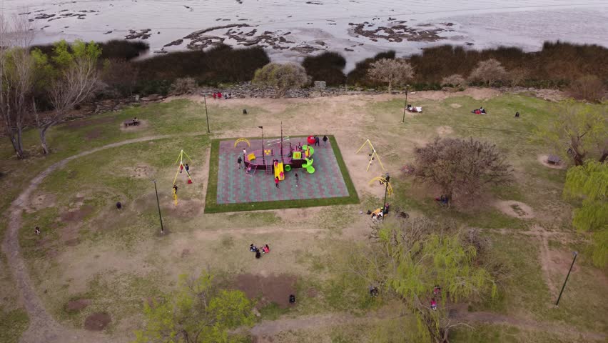 A dynamic orbital aerial footage of kids playing around the children