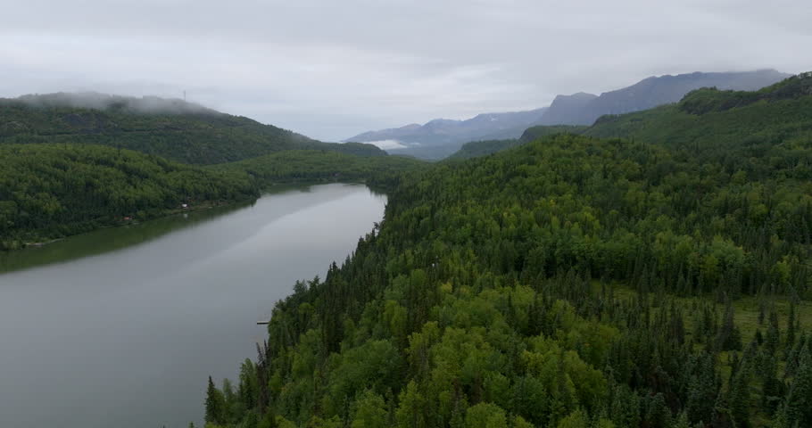 Aerial Shot Of Tranquil Denali National Park Under Clouds, Drone Flying Forward Over River