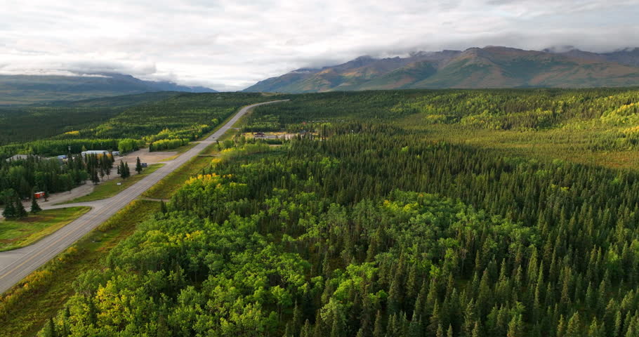 Aerial Panning Beautiful View Of Denali National Park, Drone Flying Forward Over Road Under Clouds