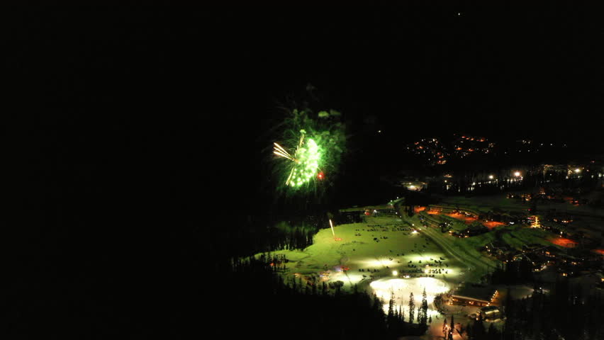 Aerial Panning Shot Of Fireworks Display In City During Winter - British Columbia, Canada