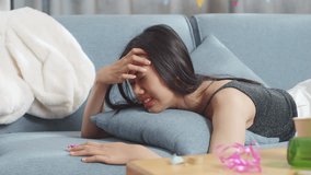 Close Up Of Drunk Asian Woman Wakes Up After Sleeping On A Sofa And Holding Her Head With Hands Due To Having A Headache In The Party Room At Home
 - Powered by Shutterstock - Get 15% off with code: PIKWIZARD15