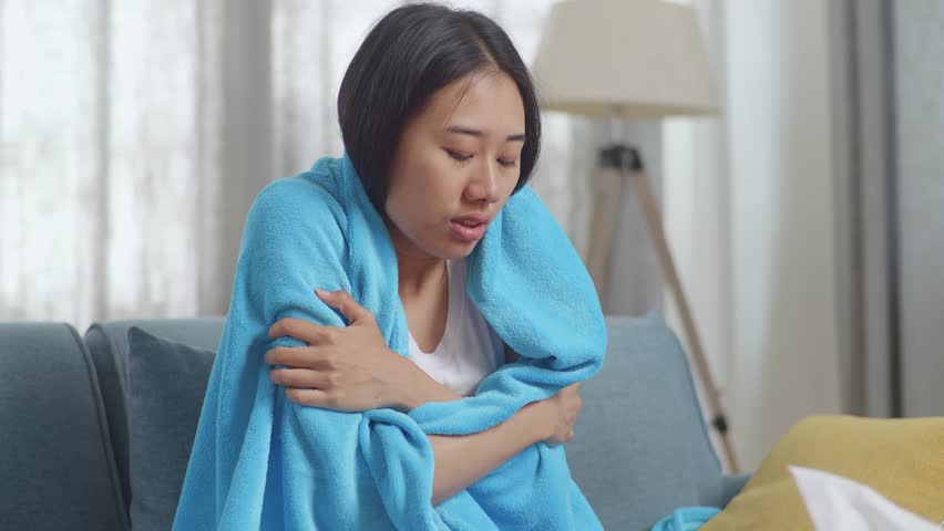 Close Up Of Sick Asian Woman With Blanket Being Cold On Sofa In The Living Room At Home
 | Shutterstock HD Video #1099311891