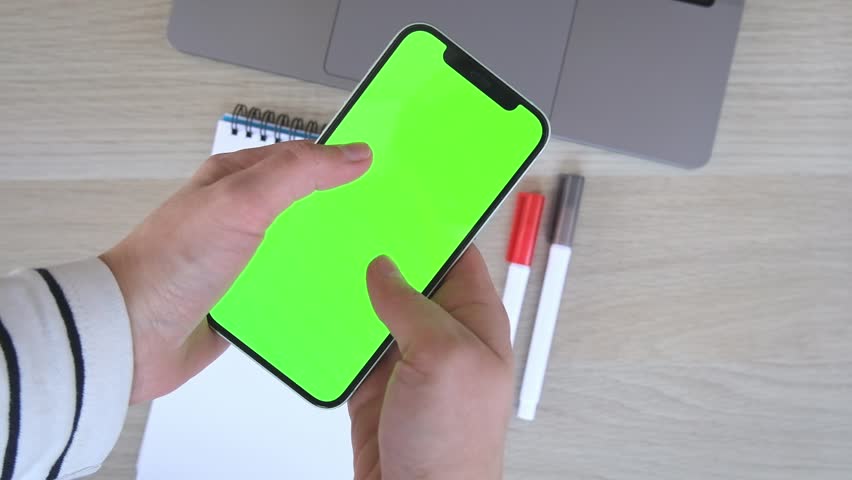 Person views scrolls the screen of a smartphone device. Zoom in on the phone screen. Green chromakey. Touching tapping zooming swiping actions. High quality FHD footage with slow motion | Shutterstock HD Video #1099313765