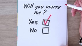 Checkboxes Yes and No, the answer is Yes. Question is Will You Marry Me. Red marker in the hand. High quality FullHD footage with slow motion - Powered by Shutterstock - Get 15% off with code: PIKWIZARD15