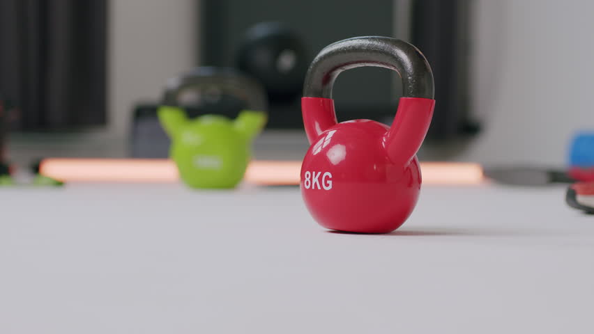 Taking the dumbbells from the floor of a gym - a close-up shot | Shutterstock HD Video #1099319997