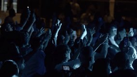 People are filming a concert on their phone. Crowd of fans at a concert of their favorite band. Raised hands. A night concert and a blue glowing stage. - Powered by Shutterstock - Get 15% off with code: PIKWIZARD15