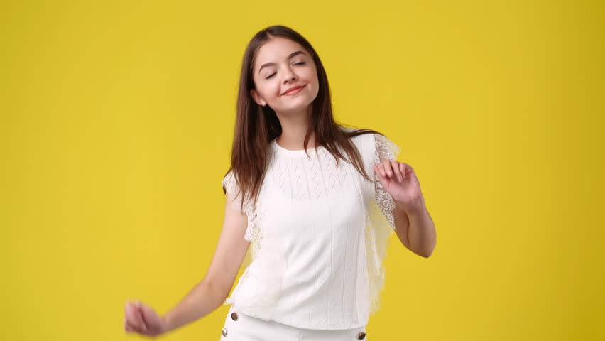4k video of one girl dancing over yellow background. | Shutterstock HD Video #1099321921