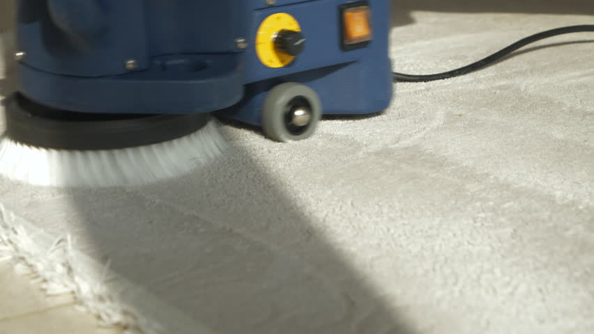 CLOSE UP: Removing particles from carpet at deep cleaning using a rotary brush. Thorough process of spring-cleaning of floor rugs with electric household accessories. Domestic housework for tidy home. | Shutterstock HD Video #1099323159