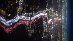 Vertical mobile oriented time lapse bright night motion of speedy night traffic in big city Los Angeles. Top view to road with white headlights and red breaks light trails, glowing streets buildings - Powered by Shutterstock - Get 15% off with code: PIKWIZARD15