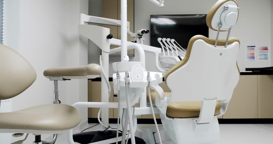 Modern Room with dental chair and medical equipment. Modern Dental office. Dental equipment at dental office and chair and other accessories. | Shutterstock HD Video #1099325969