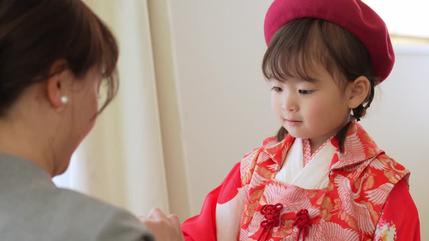 asian girl wearing kimono taking make up for celebration