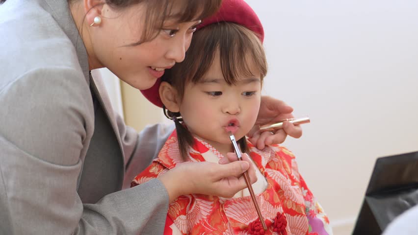 asian girl wearing kimono taking make up for celebration