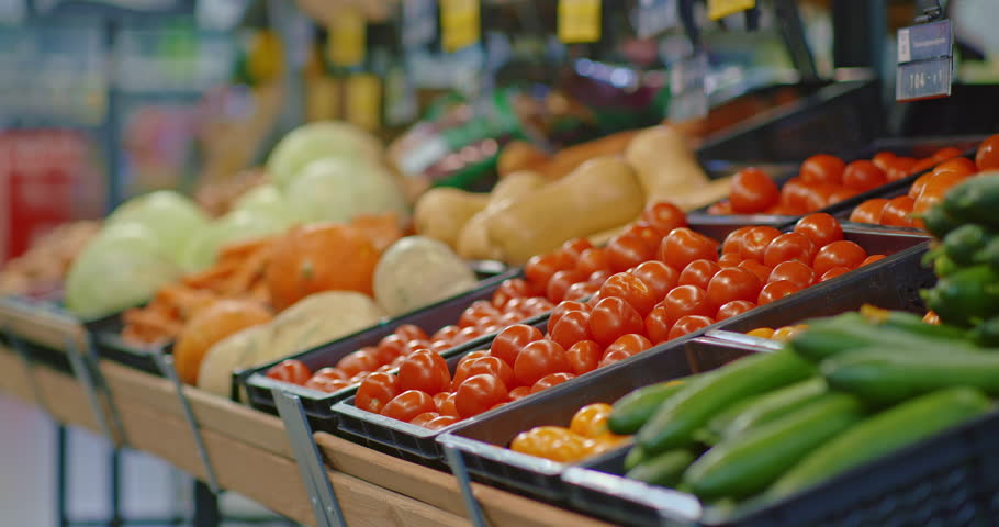 People buying vegetables in supermarket, man putting tomatoes in plastic bag, closeup, 4K, Prores | Shutterstock HD Video #1099331783