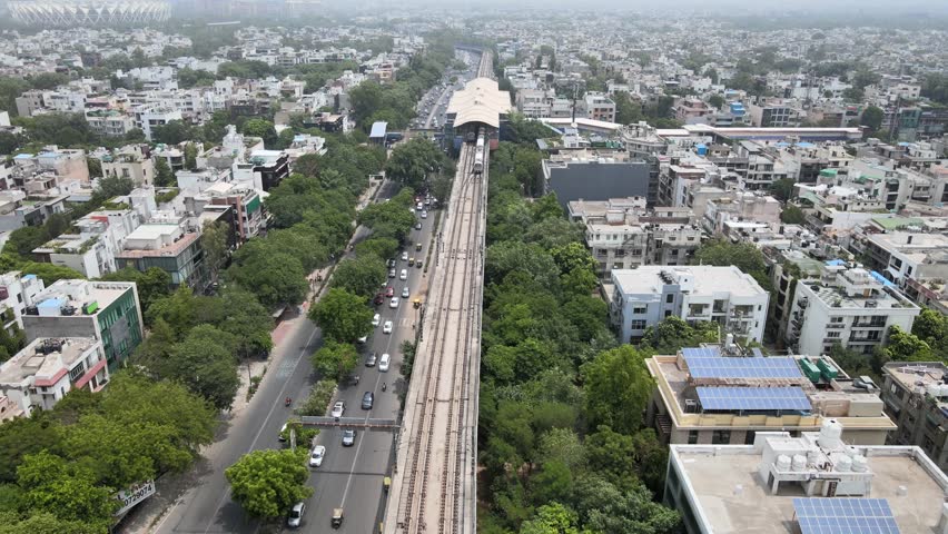 An aerial shot of the Delhi Metro moving in New Delhi, India
