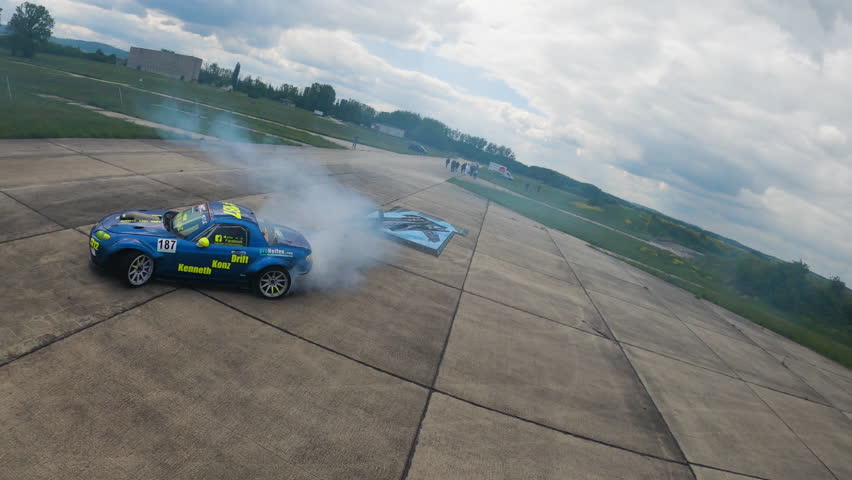 Aerial top view professional driver drifting blue race car on asphalt road track. Drone view high speed racing car on circuit.