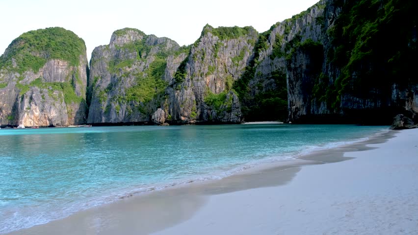 View of limestone cliffs and tropical beach at the lagoon of Maya Bay Koh Phi Phi Thailand. Tropical Island in Thailand | Shutterstock HD Video #1099340777