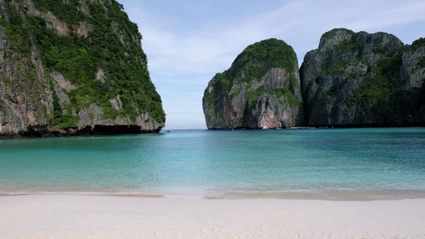 Limestone cliffs and tropical beach at the lagoon of Maya Bay Koh Phi Phi Thailand. Tropical Island in Thailand | Shutterstock HD Video #1099340823