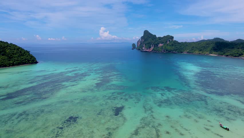 View of the turqouse colored ocean with longtail boats at Koh Phi Phi Don Thailand.  | Shutterstock HD Video #1099340889