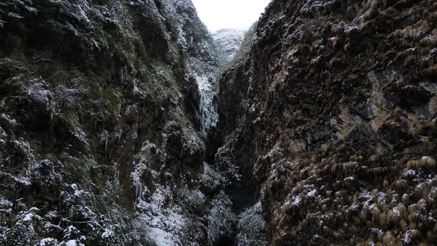 Extreme winter weather in mountain region during snowfall . Everything is frozen, wind is so cold, forest become white, houses are covered by white freah snow