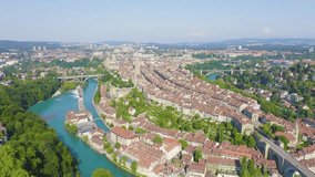 Inscription on video. Bern, Switzerland. Historic city center, general view, Aare river. Flames with dark fire, Aerial View