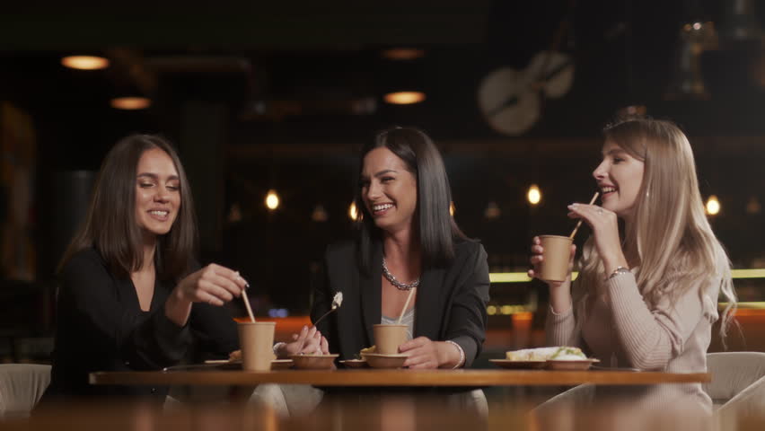 Happy group of friends hanging out in cafe chatting sharing conversation drinking coffee enjoying socializing having fun meet up in restaurant | Shutterstock HD Video #1099343805