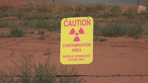 MOAB, UTAH - JUL 2015: Moab Utah UMTRA radiation uranium contamination caution 4K. Uranium mill waste situated alongside Colorado River. US Department of Energy. Cleanup cost $720 million.