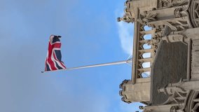 British national flag waving on building of Parliament of the United Kingdom. Flag of Great Britain is one of state symbols of state of the UK of Great Britain and Northern Ireland. Vertical video
