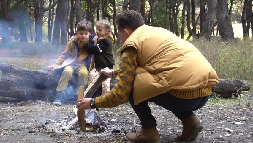 Slow Motion family making campfire together while having trip on autumn day | Shutterstock HD Video #1099354777