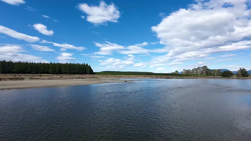 A beautiful daytime view of a lake coast in Rabbit Island, Nelson Bays, New Zealand