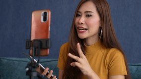 Asian women life Coach video call with students to suggest success business way. Young entrepreneur streaming in social media, Freedom and active lifestyle concept, Communicate sales via live video.