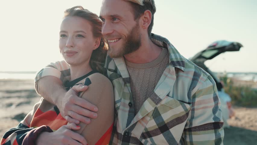 Laughing blond couple talking and hugging near estuary outdoors | Shutterstock HD Video #1099356053