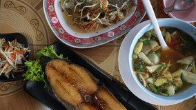 Family or friend order food to eat lunch seafood manly seafood menu in the restaurant. Thai seafood