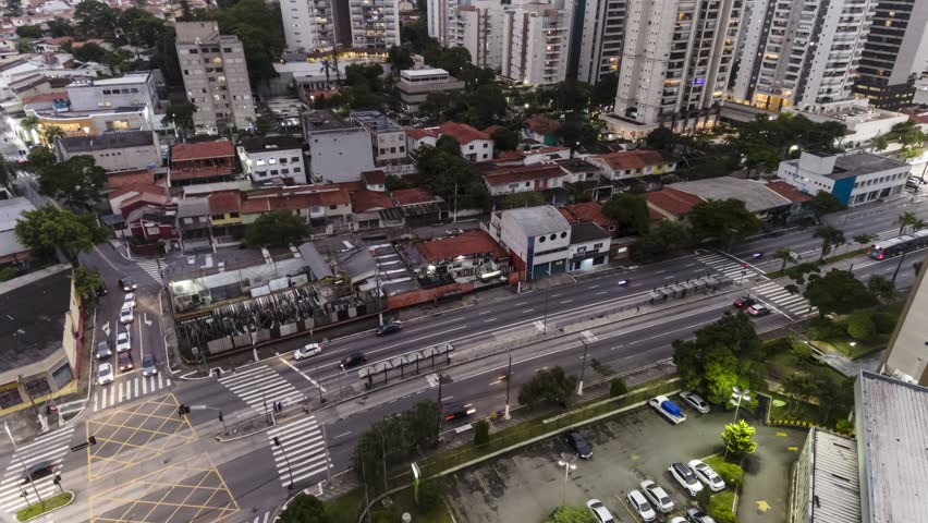 Top view of vehicle traffic on an avenue with a bus lane during dusk in the city of Sao Paulo