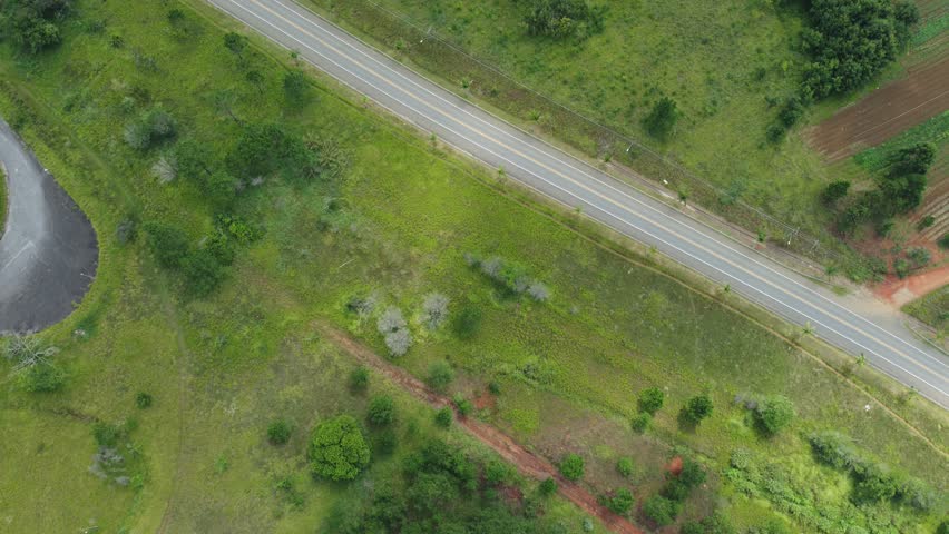 A road in Mogi das Cruzes capture by a drone near trees in Brazil. 