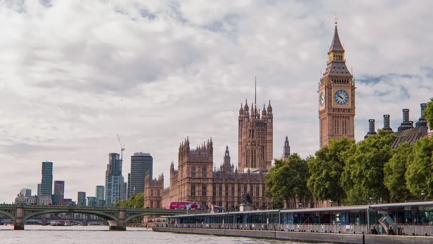 Cinematic moving shot of London Westminster Bridge, Palace of Westminster Big Ben and Thames River England, United Kingdom on a beautiful sunny day Royalty-Free Stock Footage #1099367113