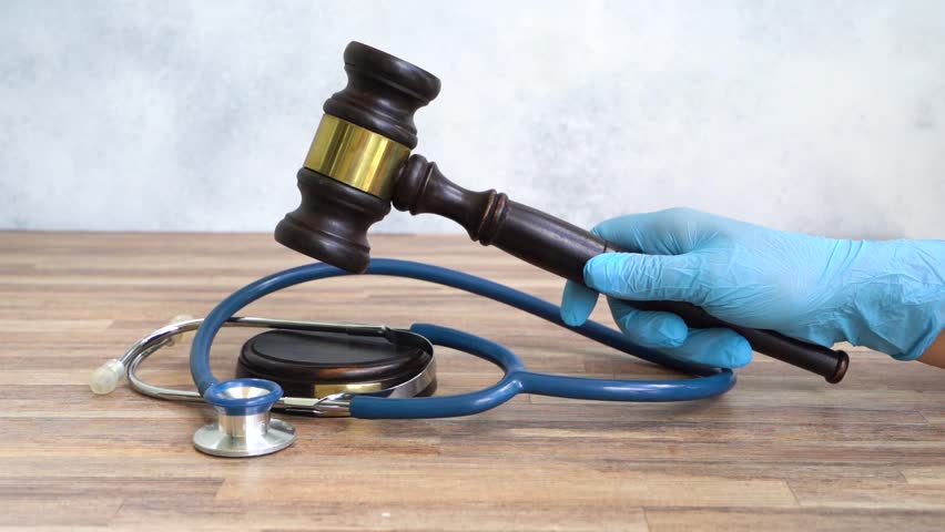 someones hand with law gavel in hand, medical law concept