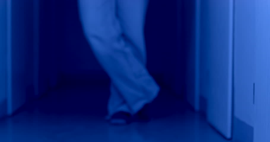 legs of a girl in socks and jeans are on the floor in the flashing lights of the police flashing lights. She takes steps, fear, changes her posture from confident to unsure. Royalty-Free Stock Footage #1099374759