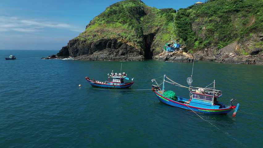 Fisherman ships in Vietnam at anchor preparing in the fishing a against the backdrop of a beautiful landscape and a wonderful mountains on a sunny day. On sunny morning Fisherman ships