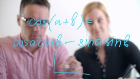 Coworkers write the equation on a glass board with a blue marker. A man and a woman look for the solution in a meeting room of a modern office. High quality 4k footage - Powered by Shutterstock - Get 15% off with code: PIKWIZARD15