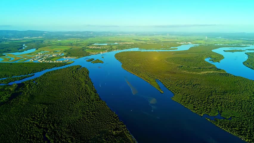 Aerial shot of the wetland of Australia, the blue river, the green swamp