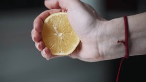 Female hand squeezing fresh lemon on blurred background. Slow motion view of a woman making citrus juice - Powered by Shutterstock - Get 15% off with code: PIKWIZARD15