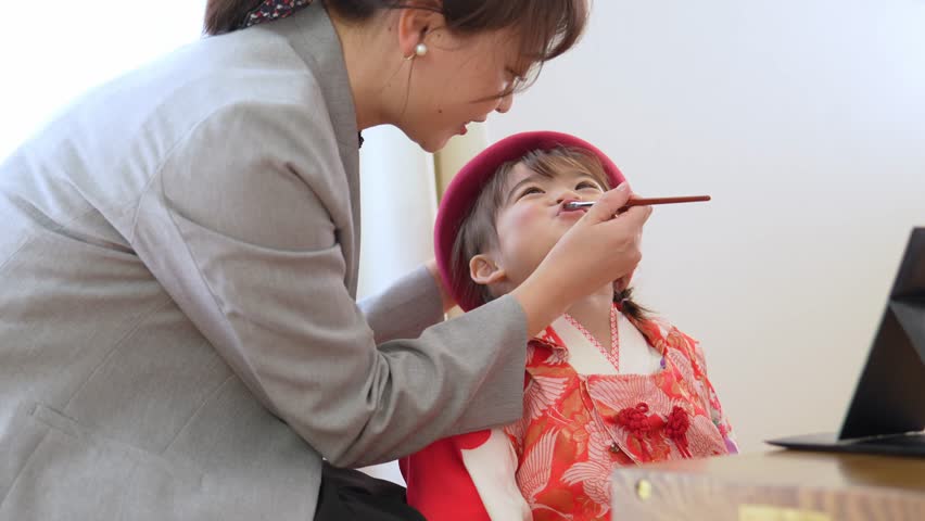 asian girl wearing kimono taking make up for celebration