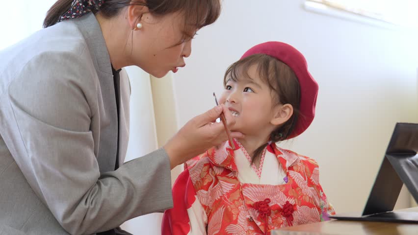 asian girl wearing kimono taking make up for celebration