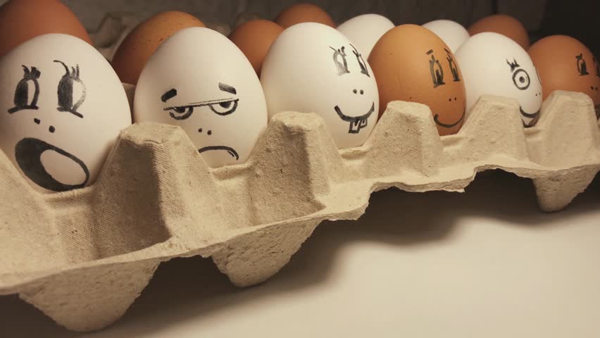 Eggs painted in cartoon faces with different grimaces. Funny and interesting cartoon faces.