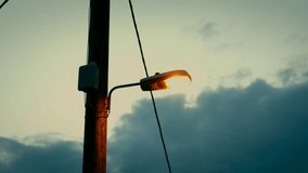 Spacey Street Lamp on Telephone Pole at Dusk Sunset Hand Held Walk - Powered by Shutterstock - Get 15% off with code: PIKWIZARD15